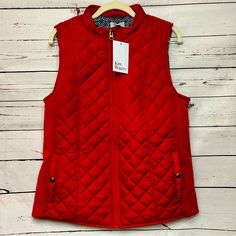 Add A Pop Of Color To Your Outfit With This Red Kim Rogers Quilted Vest. Made From Polyester With Spandex Sides, This Mid-Length Vest Features A Geometric Pattern And Sleeveless Design, Making It Perfect For Any Season. The Zip Closure And Pockets Add Both Style And Functionality, While The Accents Give It A Unique Flair. Suitable For Travel, Workwear, Casual Outings, Or Even Business Events, This Vest Is A Versatile Addition To Your Wardrobe. Available In Size M, It Is A Regular Fit And Will Co Workwear Casual, Kim Rogers, Business Events, Quilted Vest, Mid Length, Work Wear, Color Pop, Geometric Pattern, Perfect Fit