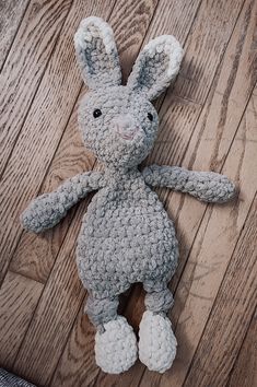 a crocheted stuffed animal laying on top of a wooden floor