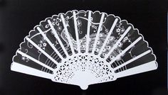 a black and white photo of a hand fan with intricate designs on the front side