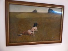 an oil painting of a woman kneeling in a field