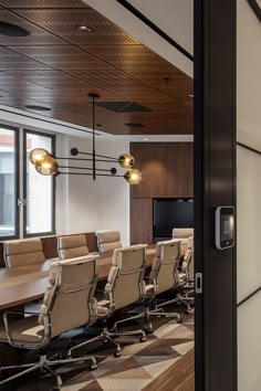 an empty conference room with chairs and a flat screen tv