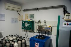 a room with several different types of water heaters on the wall and in front of them