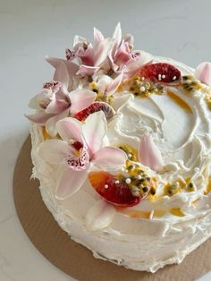 a cake with white frosting and flowers on top