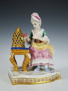 a figurine sitting on top of a table next to a lamp