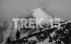 two people standing on top of a mountain with the words trek 15 in front of them