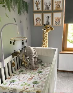 there is a baby crib in the room with giraffes on it