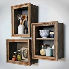 three wooden shelves with various items on them and one shelf is holding utensils