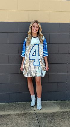 SHIP SAME DAY IF ORDER BY 4 PM. Your Game Day Sparkle will be seen by everyone in this Show Stopping Sequin Jersey No. 4 Mini Dress/Top! Wear over jeans or leggings for a Tunic look, Tucked In with Jeans, Shorts or Skirt or wear it with boots or heels as a Dress! Dress is fully sequined on front. NOTE: This is a One Size Fits Most. As such it will fit and look different on everyone. One Size Regular  Will fit from a Small to Large There is Stretch.  Also depends on Body Type, Body Length and Leg Jersey Party Outfit, Sequin Jersey, Dress Top, Football Jersey, Top Dress, Dallas Cowboys, Dress Clothes For Women, Jeans Shorts, Sequin Dress