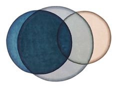 three circular rugs in different colors on a white background