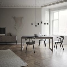 a dining room table and chairs in front of a window