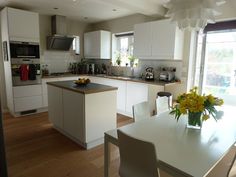 the kitchen is clean and ready to be used for cooking or dining room furniture, as well as flowers on the table