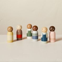 a group of small wooden dolls standing next to each other