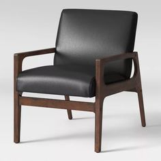 a black leather chair with wooden frame and armrests, viewed from the front