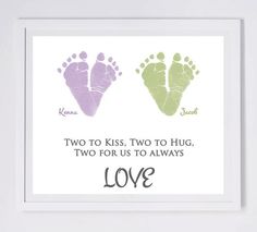 two baby footprints with the words love written on them in green, purple and pink