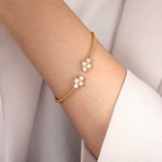 Adorn your wrist with this 14K yellow gold Bujukan bangle, featuring four lustrous cultured pearl rounds as the crowning jewels of a perfectly strand of Bujukan beading. The elegant and sophisticated style exudes luxurious glamour. Slip it on and feel like royalty, worn alone or stacked, the pearls and beading will create a majestic and regal aura around your wrist. Jewellery Lookbook, Pearl Bangles Gold, Bracelets Stack, Pearl Bangle Bracelet, Wear Pearls, Pearl Bangle, Open Bangle, Jewelry Lookbook, Jewellery Design