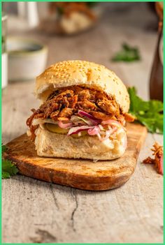 a pulled pork sandwich on a wooden cutting board