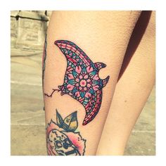 a woman's leg with a tattoo on it that has an image of a fish