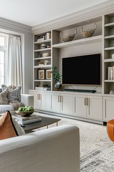 a living room filled with furniture and a flat screen tv on top of a wooden entertainment center