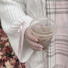 a woman holding a cup of coffee in her hands