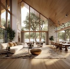 a living room filled with lots of furniture and large windows over the top of it