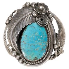 Navajo Kingman turquoise and sterling racelet. Beautiful large stone surrounded by twisted rop leaves, flowers and scrolls. Some flexibility to the wrist. Nice patina that can be buffed out easily to make shine. PERIOD: Late 20th Century ORIGIN: Southwest - Navajo, Native American SIZE: 5 1/2" Opening 1 1/4" Face 3" Bracelets, Jewelry, Kingman Mine Turquoise, Sterling, Native American Jewelry Family Owned & Operated Cisco’s Gallery deals in the rare, exceptional, and one-of-a-kind pieces that de Jewelry Markings, Silver Smithing, Morenci Turquoise, Native American Jewelry Navajo, American Indian Jewelry, Large Stone, Sterling Bracelets, Navajo Turquoise, Aquamarine Jewelry