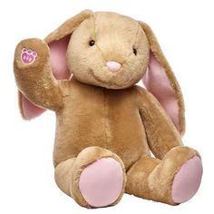 a brown stuffed animal with pink ears