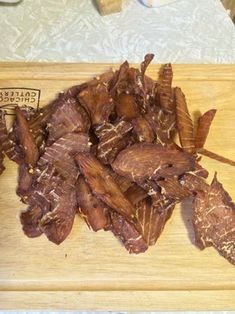 some meat is on a cutting board and ready to be cut into bite sized pieces