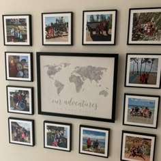 a group of people standing in front of a wall with pictures on it