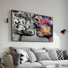 a living room filled with furniture and a large painting on the wall above it's head