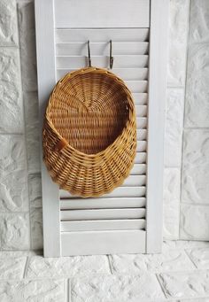 a basket hanging on the side of a wall