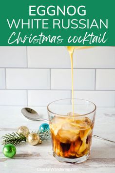 an eggnog white russian christmas cocktail is being poured into a glass with ice