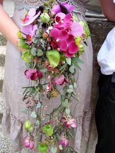 a woman holding a bouquet of flowers in her hands