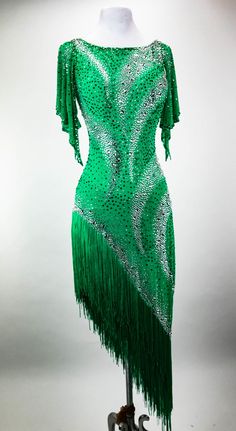 a green dress with fringes is on display