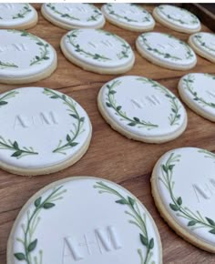 some cookies with leaves on them sitting on a wooden table next to the words mm and m