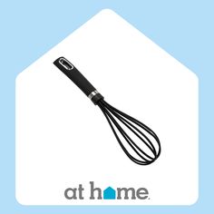 a black whisk sitting on top of a blue and white sign that says at home