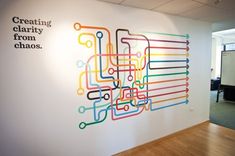 an office wall with colorful lines painted on it