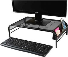 a computer desk with a keyboard, mouse and monitor sitting on it's stand