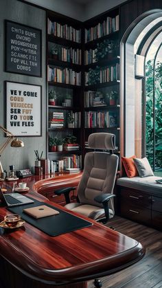 an office with a desk, chair and bookcase in front of a large window