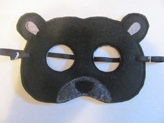 a black bear mask with two ears and nose holes on the front, made out of felt