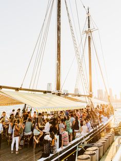 a group of people standing on the deck of a boat