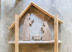 a nativity scene made out of wood on a shelf