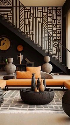 a living room filled with lots of furniture next to a stair case on the wall