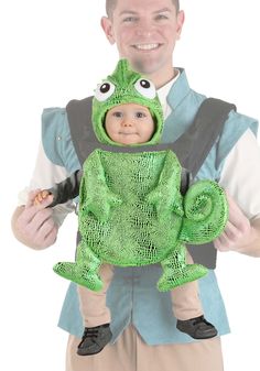 a man is holding a baby in a costume that looks like a chamelon