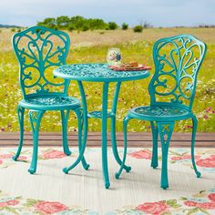 two chairs and a table on a rug outside