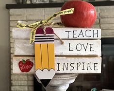 a stack of books with an apple on top and some words taped to the front