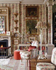 a living room filled with furniture and a fire place in front of a painting on the wall