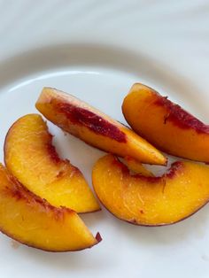 slices of peaches on a white plate