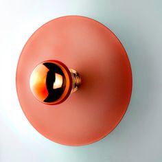 an orange and black knob on a white wall with a red circle around the top