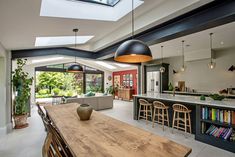 an open kitchen and dining room with skylights