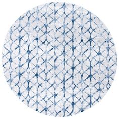 a round rug with blue and white designs on it